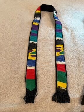 Colorful Handwoven Cotton Belt with Fringe on Black Background